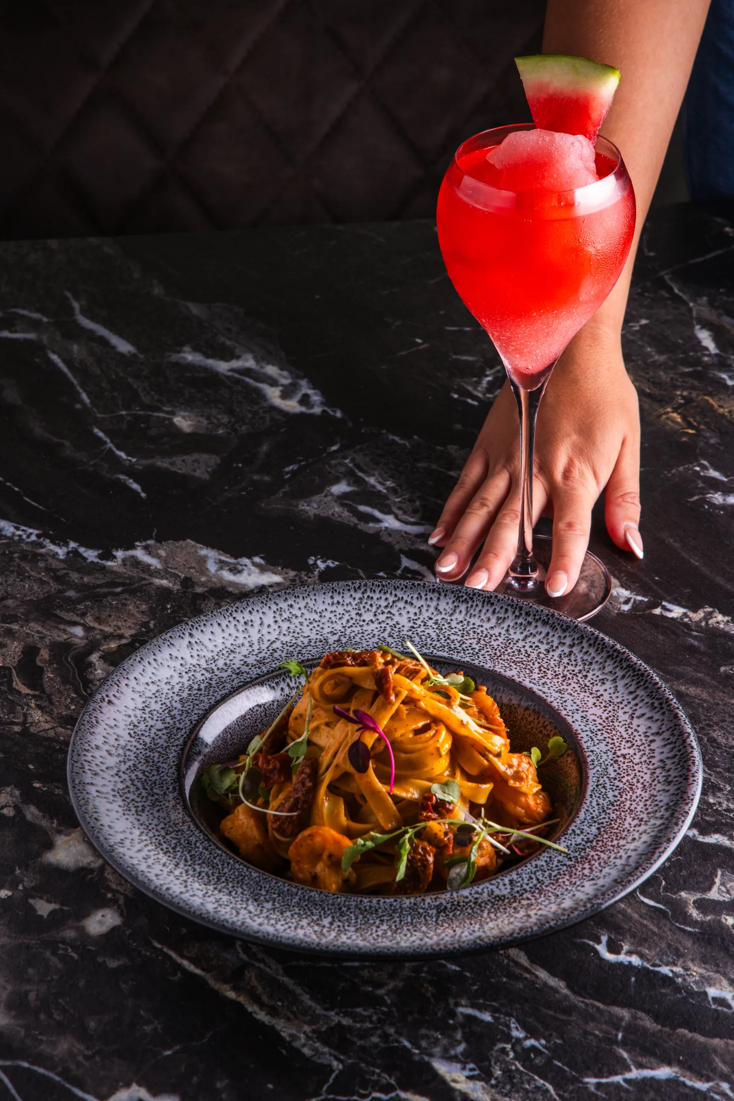 Pasta dish in front of Onyx wall