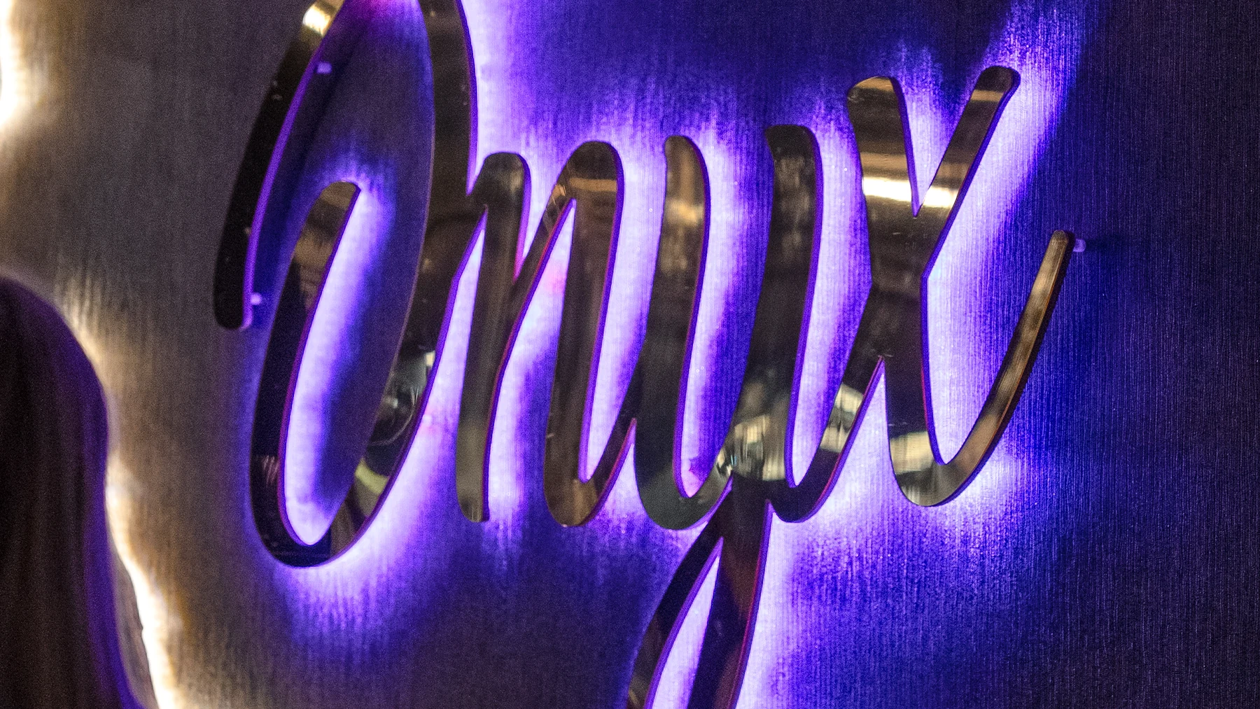Close-up Onyx wall sign with purple glow